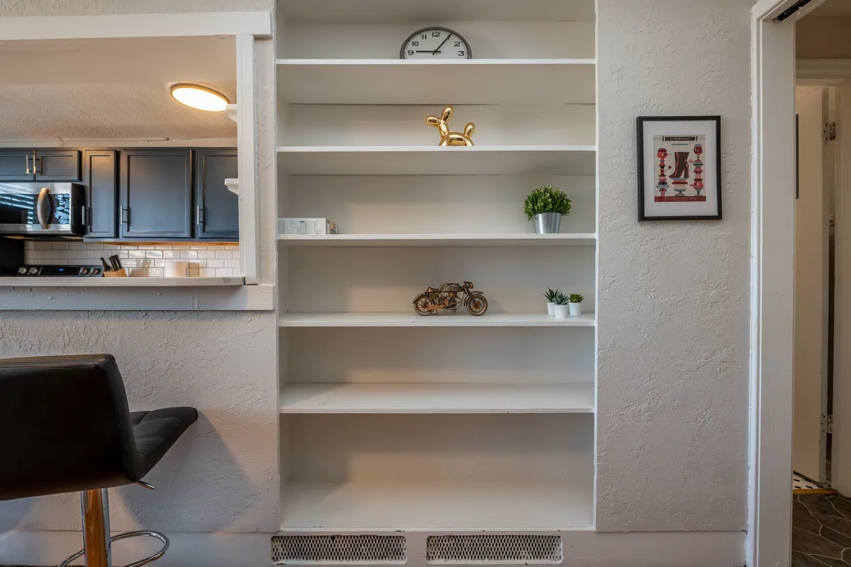 While not a traditional bathroom scene, this image shows interior shelves, decorative items, and a clock, suggesting thoughtful storage solutions and an organized, welcoming vibe. The presence of decor and personal touches creates a homey atmosphere that subtly echoes the section’s emphasis on comfort and convenience.